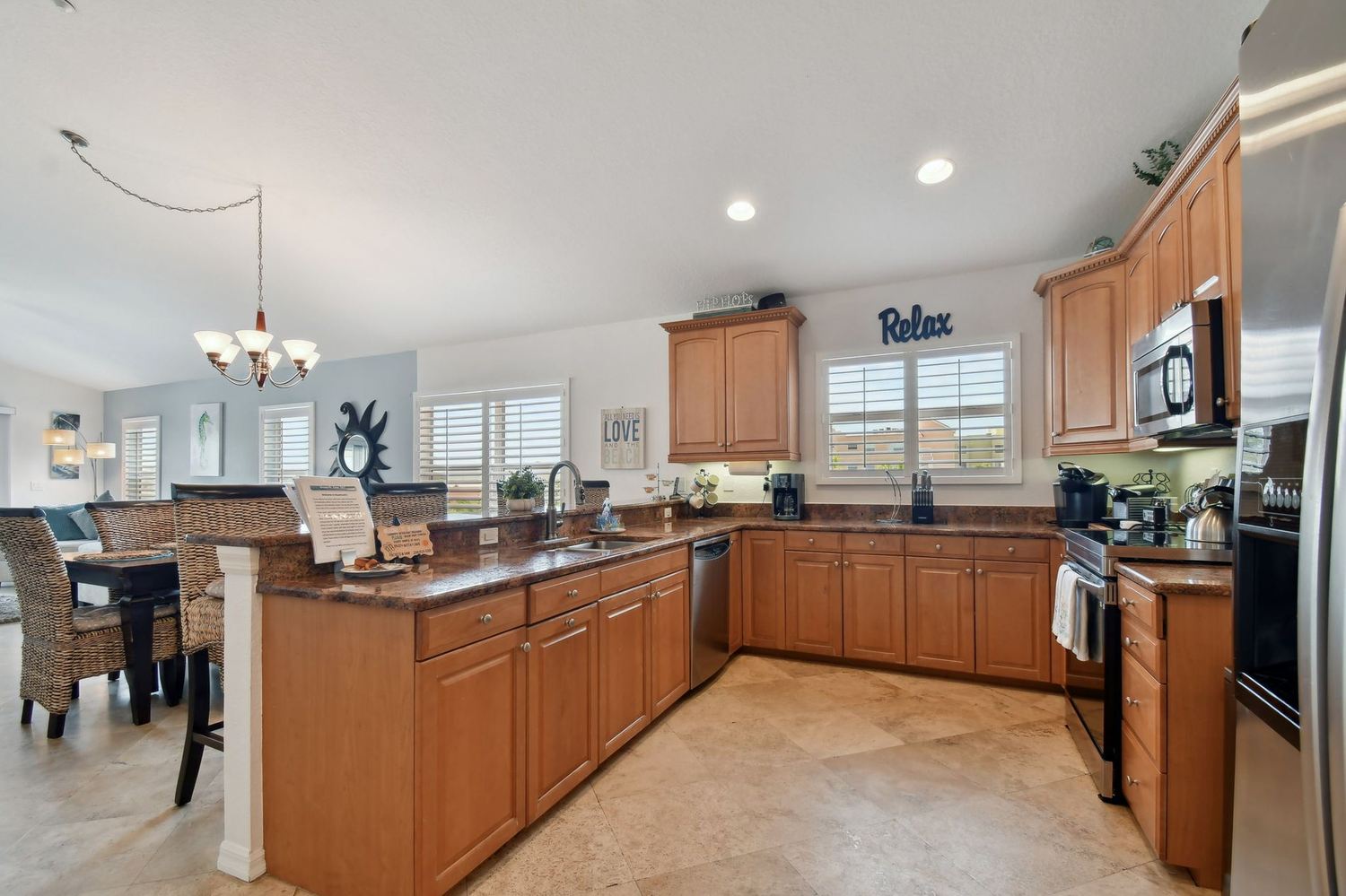 Kitchen with granite counters, stainless appliances and a breakfast bar opening onto the dining room