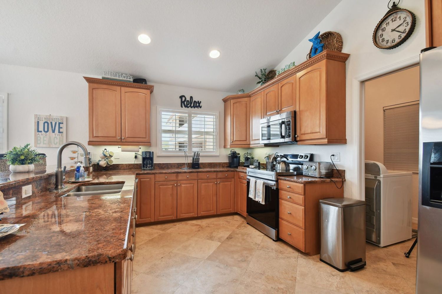 Kitchen with granite counters, stainless range and microwave